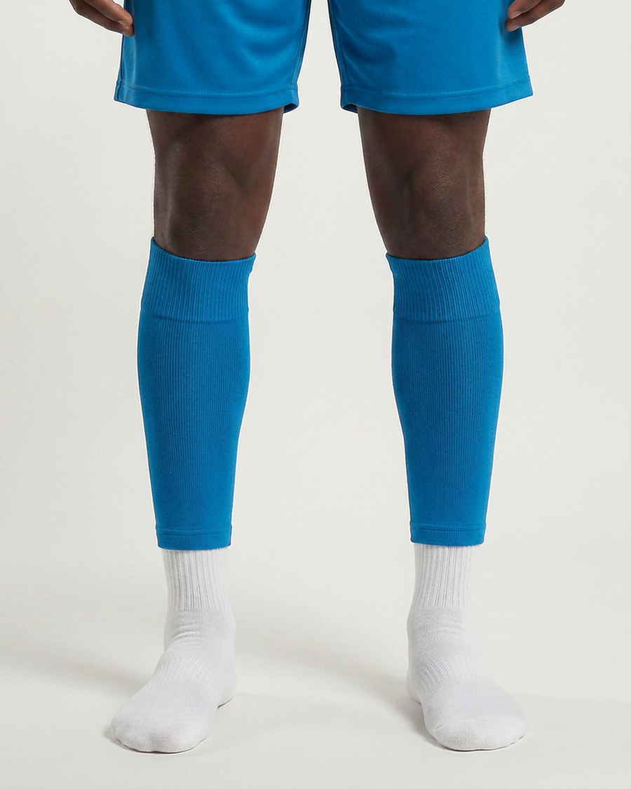 Farrellys World football sock sleeve worn over a white crew sock - Cyan