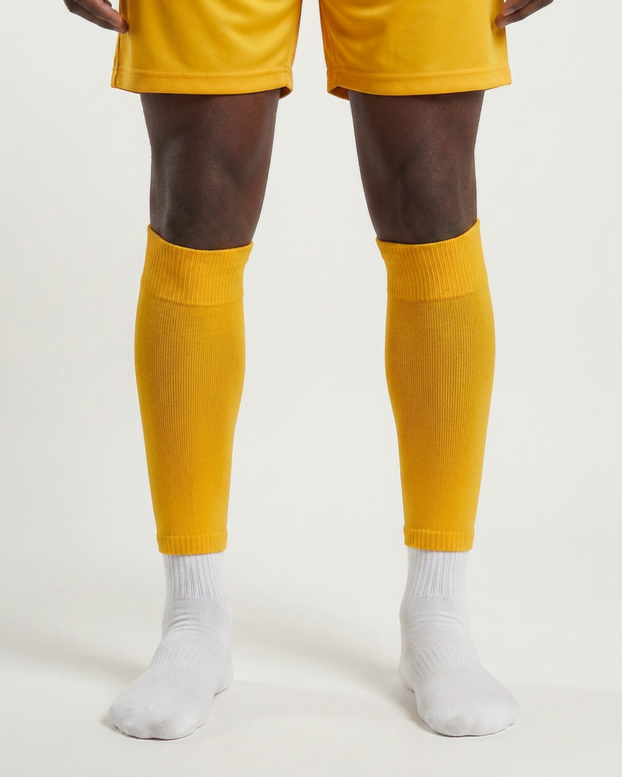 Farrellys World football sock sleeve worn over a white crew sock - Gold