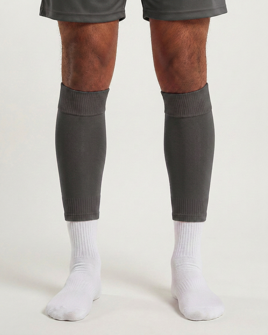 Farrellys World football sock sleeve worn over a white crew sock - Dark Grey