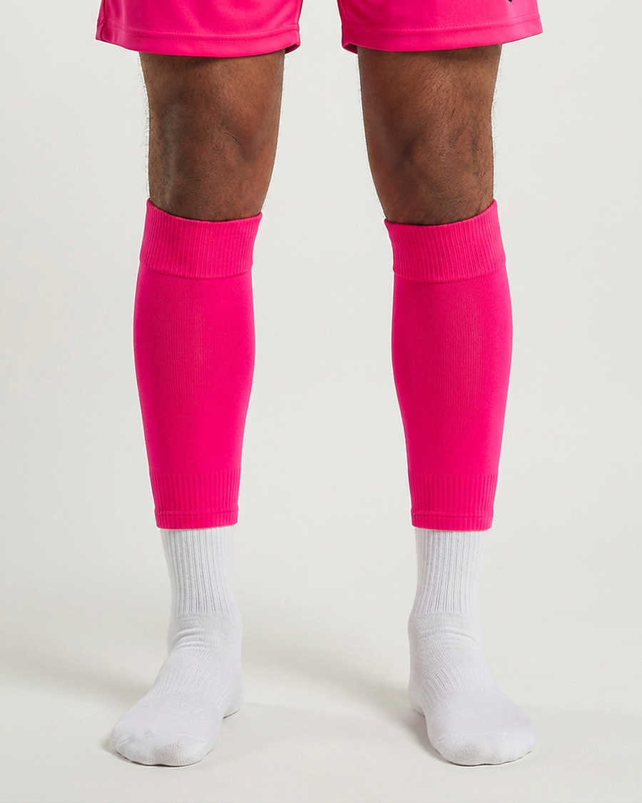 Farrellys World football sock sleeve worn over a white crew sock - Fluo-Pink