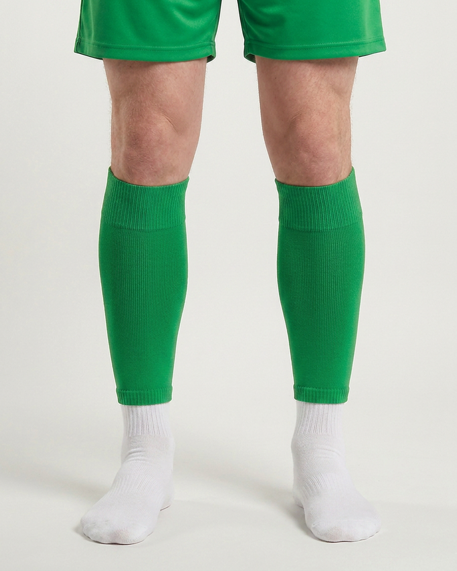 Farrellys World football sock sleeve worn over a white crew sock - Parrot Green