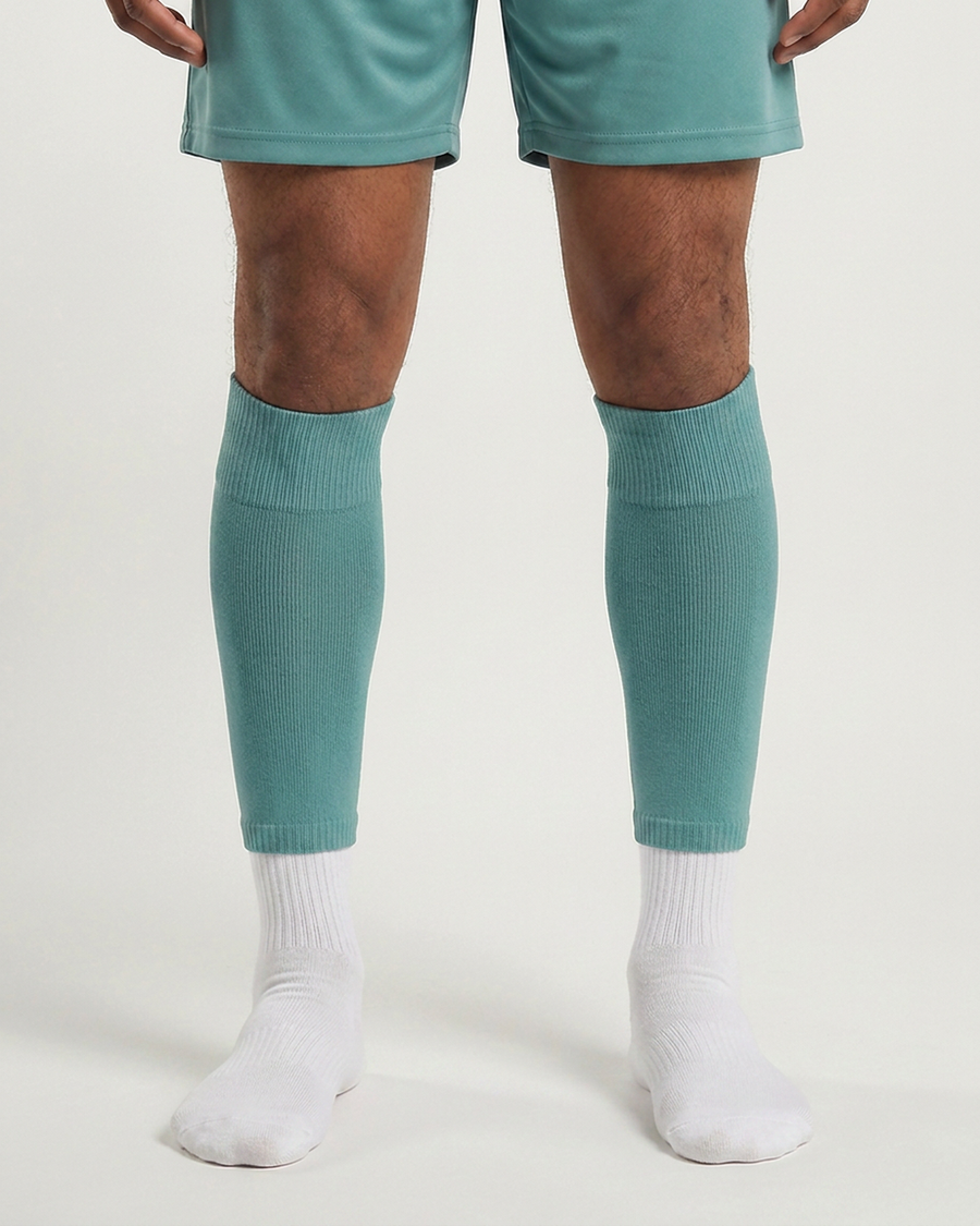 Farrellys World football sock sleeve worn over a white crew sock - Teal